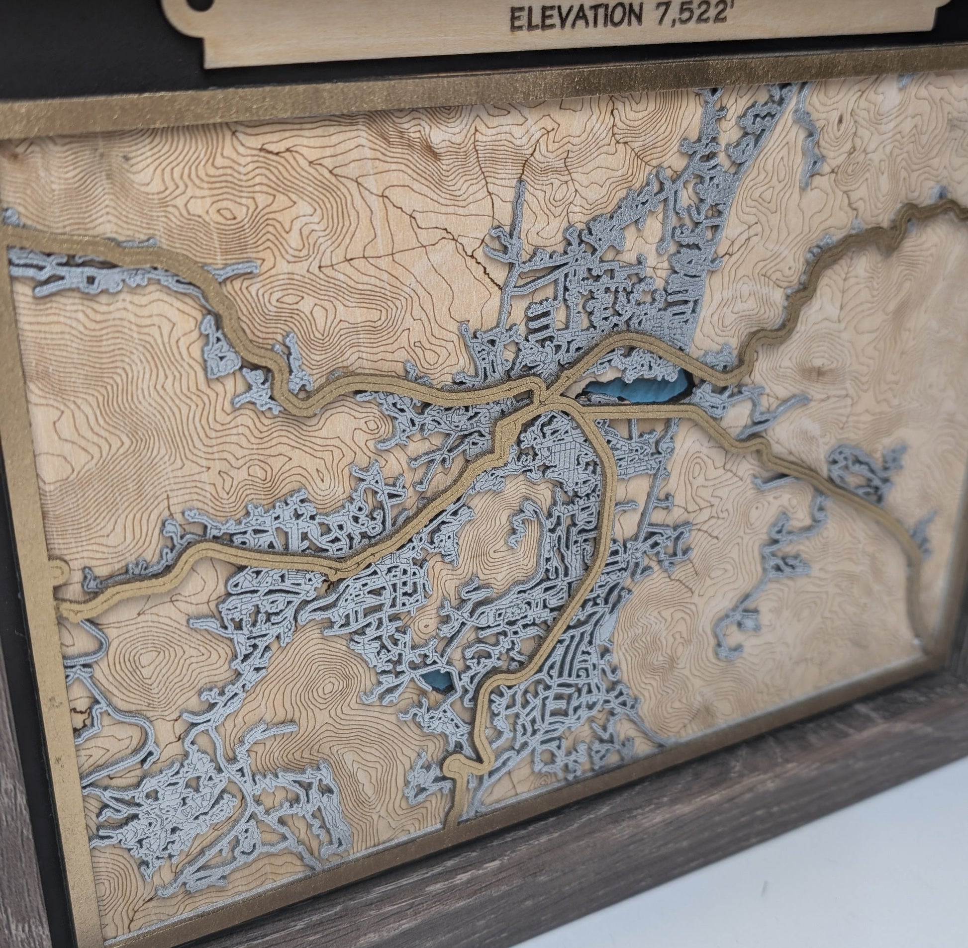 Topographic map of Estes Park, Colorado with elevation details on a wooden frame.