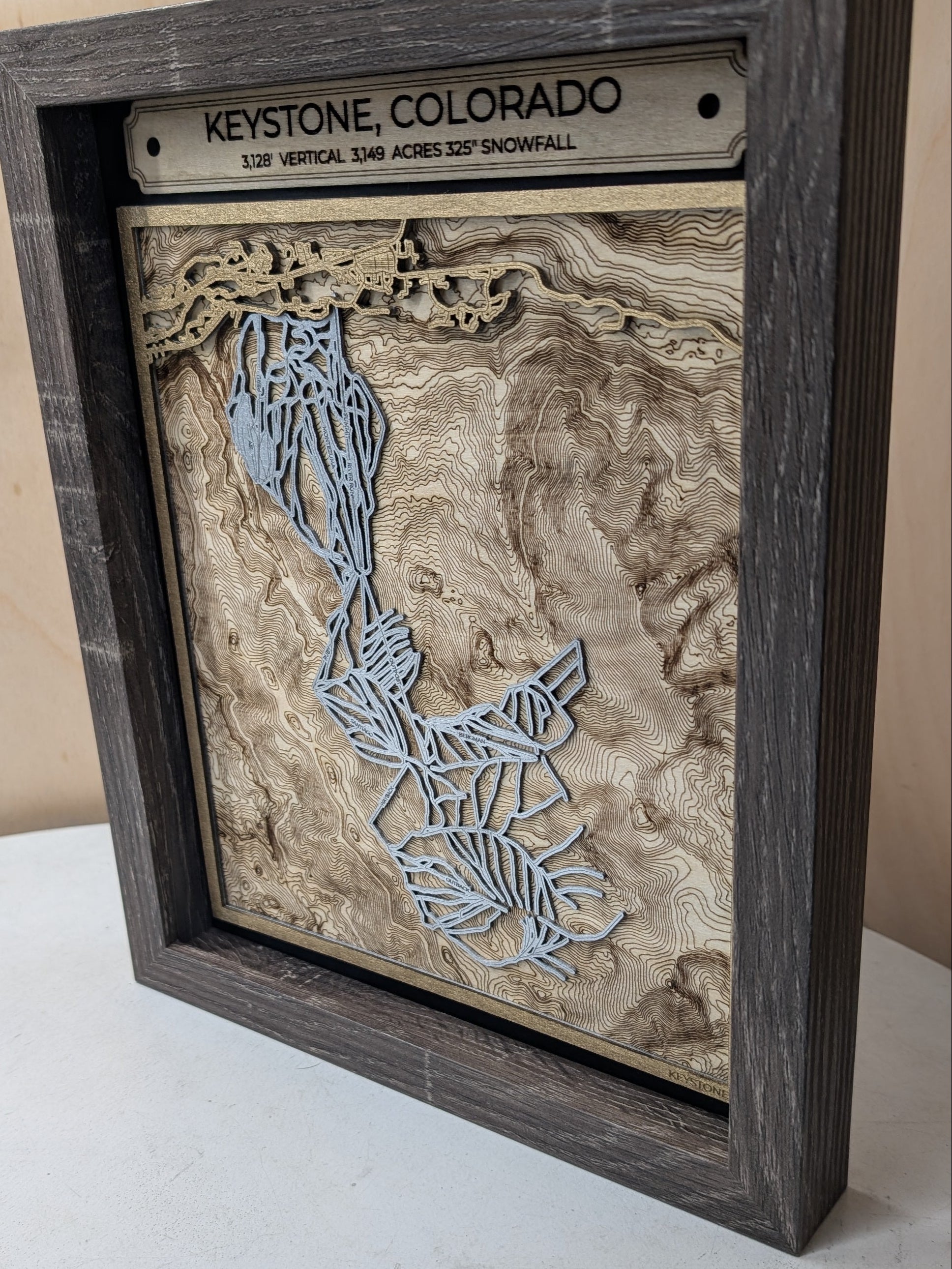 Wooden map of Colorado with 'Keystone, Colorado' on a wooden plaque.