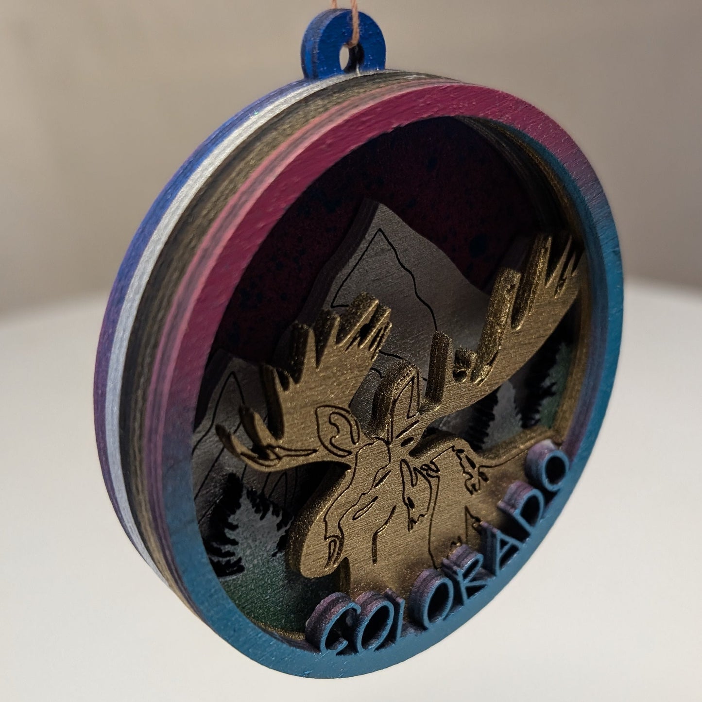Decorative ornament with moose design and 'Colorado' text on a white surface.