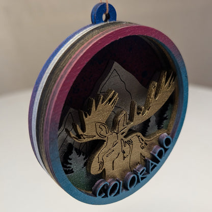 Decorative ornament with moose design and 'Colorado' text on a white surface.